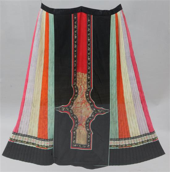 A Chinese black satin and multi-coloured silk damask wedding skirt, c.1900, length 81cm, removable perspex case